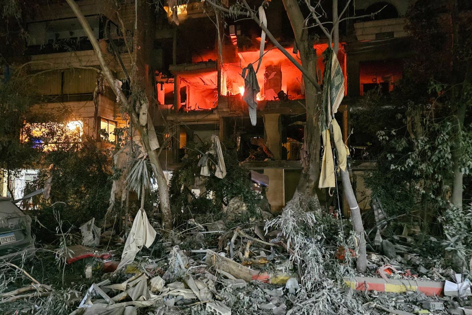 Severe destruction of civilian infrastructure in a Lebanese neighborhood at night
