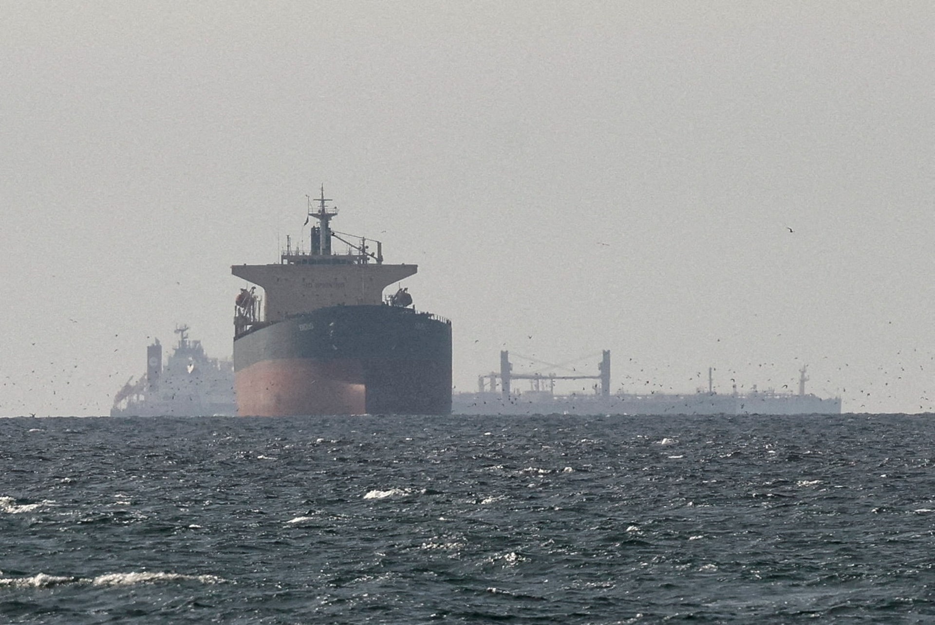 A large oil tanker navigating the waters of the Strait of Hormuz