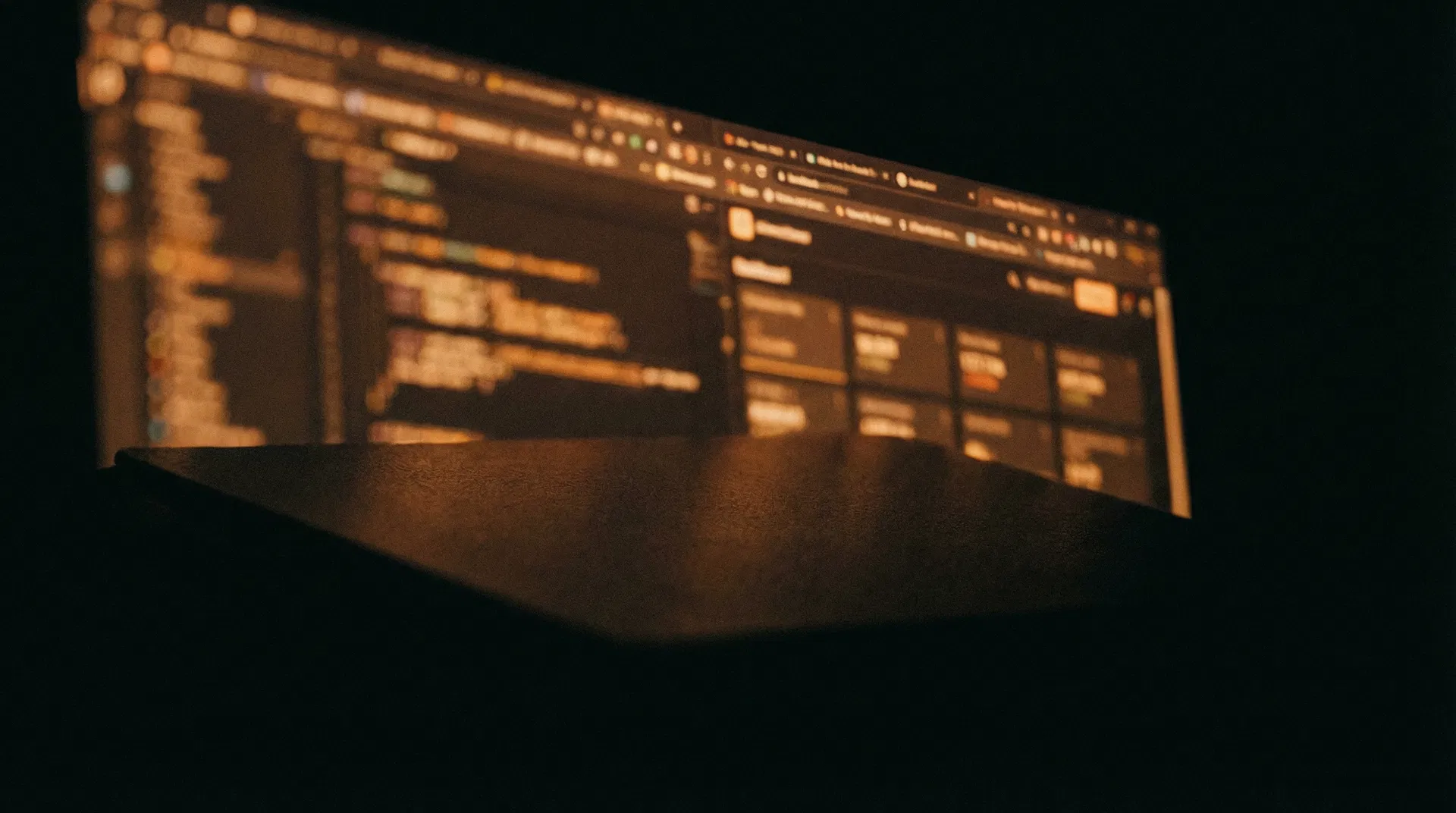 Operator working at a computer screen in a dark room