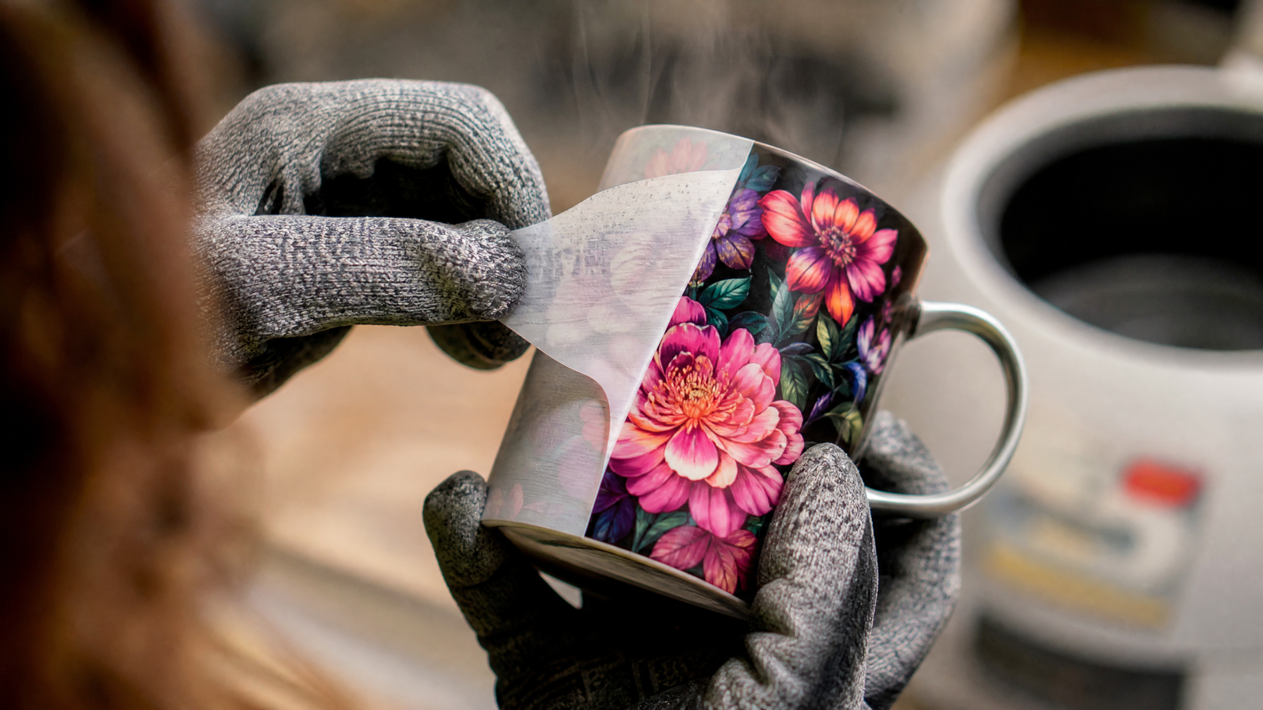 Sublimation for Beginners: Crafter peeling sublimation paper off a ceramic mug to reveal a vibrant floral design.