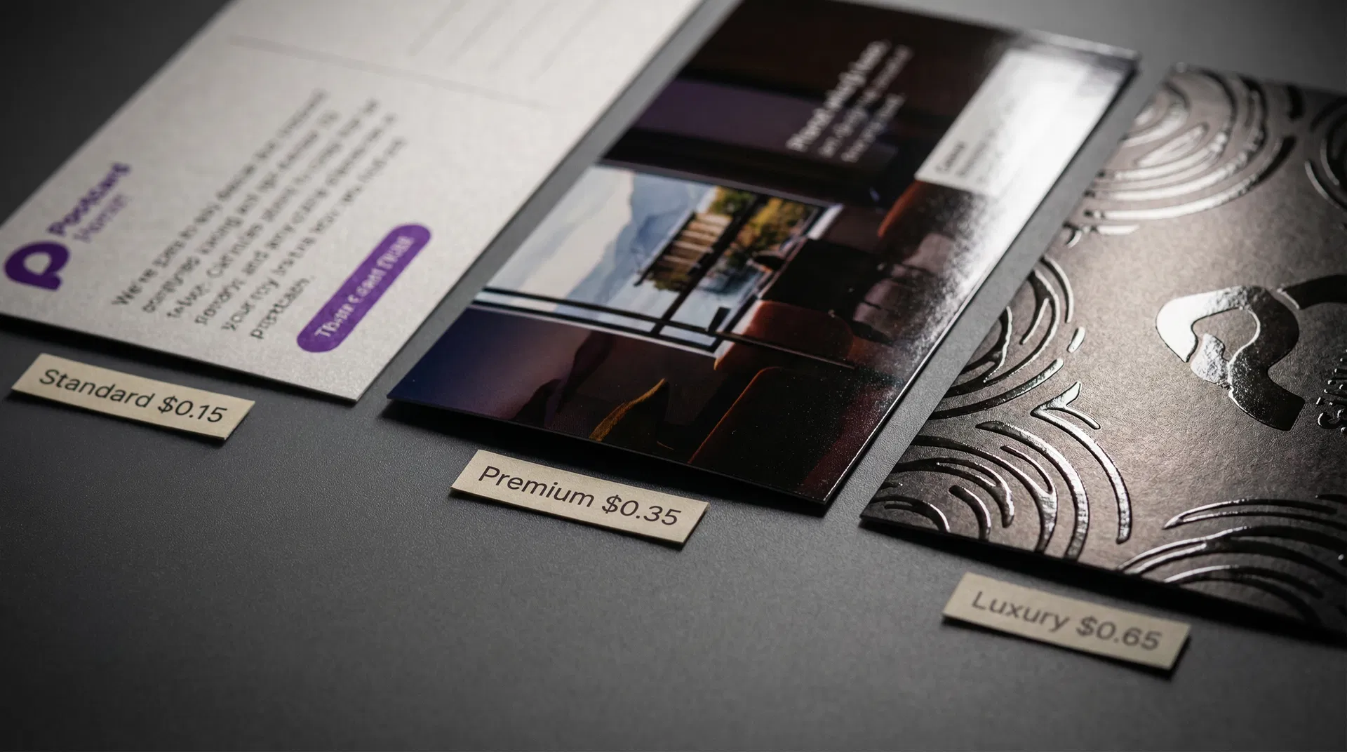 Three postcards showing standard, premium, and luxury printing quality with visible differences
