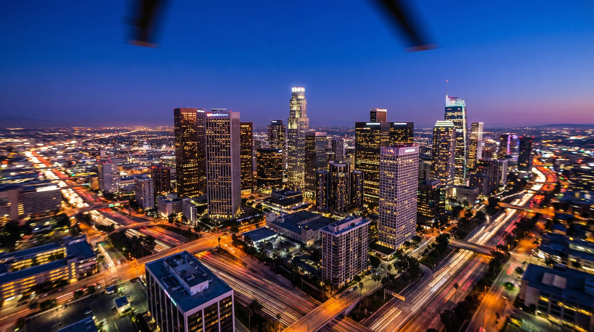 Downtown Los Angeles helicopter tour at dusk — aerial view of the LA skyline and city lights