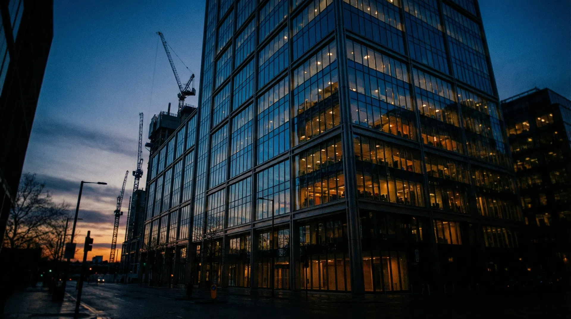 Modern commercial office tower at dusk