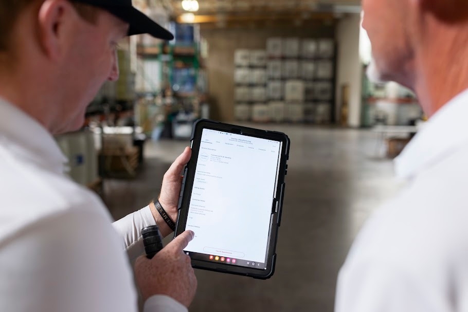 Pest control technician using a tablet for scheduling Pest control technician using a tablet for scheduling