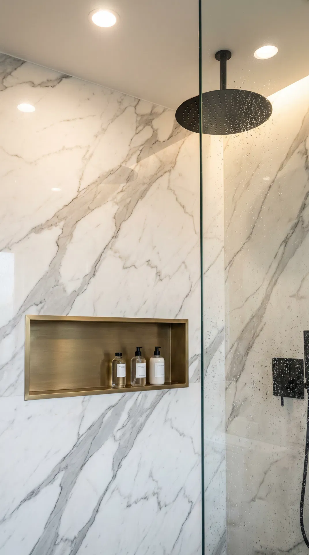 Luxury walk-in shower with marble and brass niche
