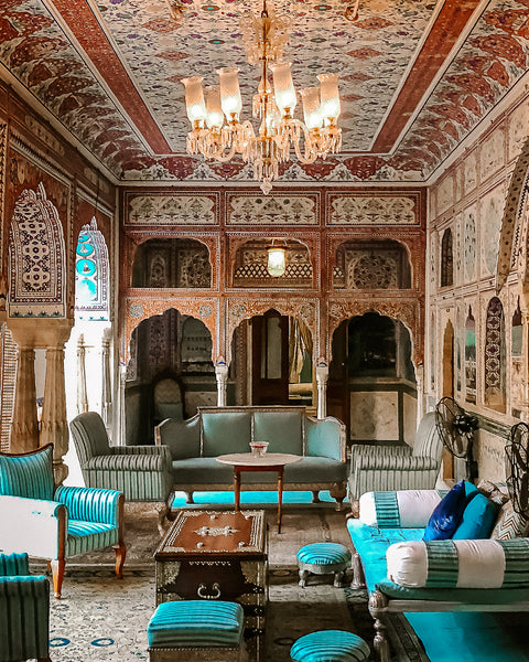 Indian living room with vibrant textiles and a rich, colorful palette.