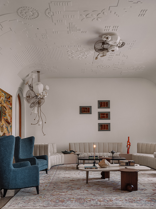 A unique, sculptural statement light fixture in a contemporary Indian living room.