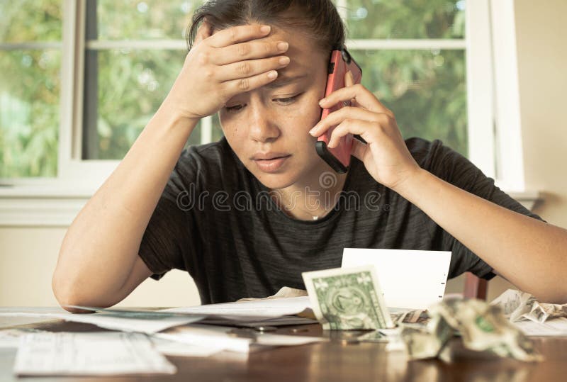 A stressed woman looking at bills