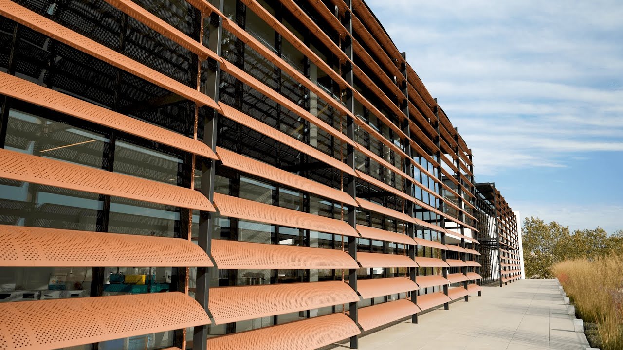 Exterior orange metal louvers, controlling heat and light from an exterior perspective.