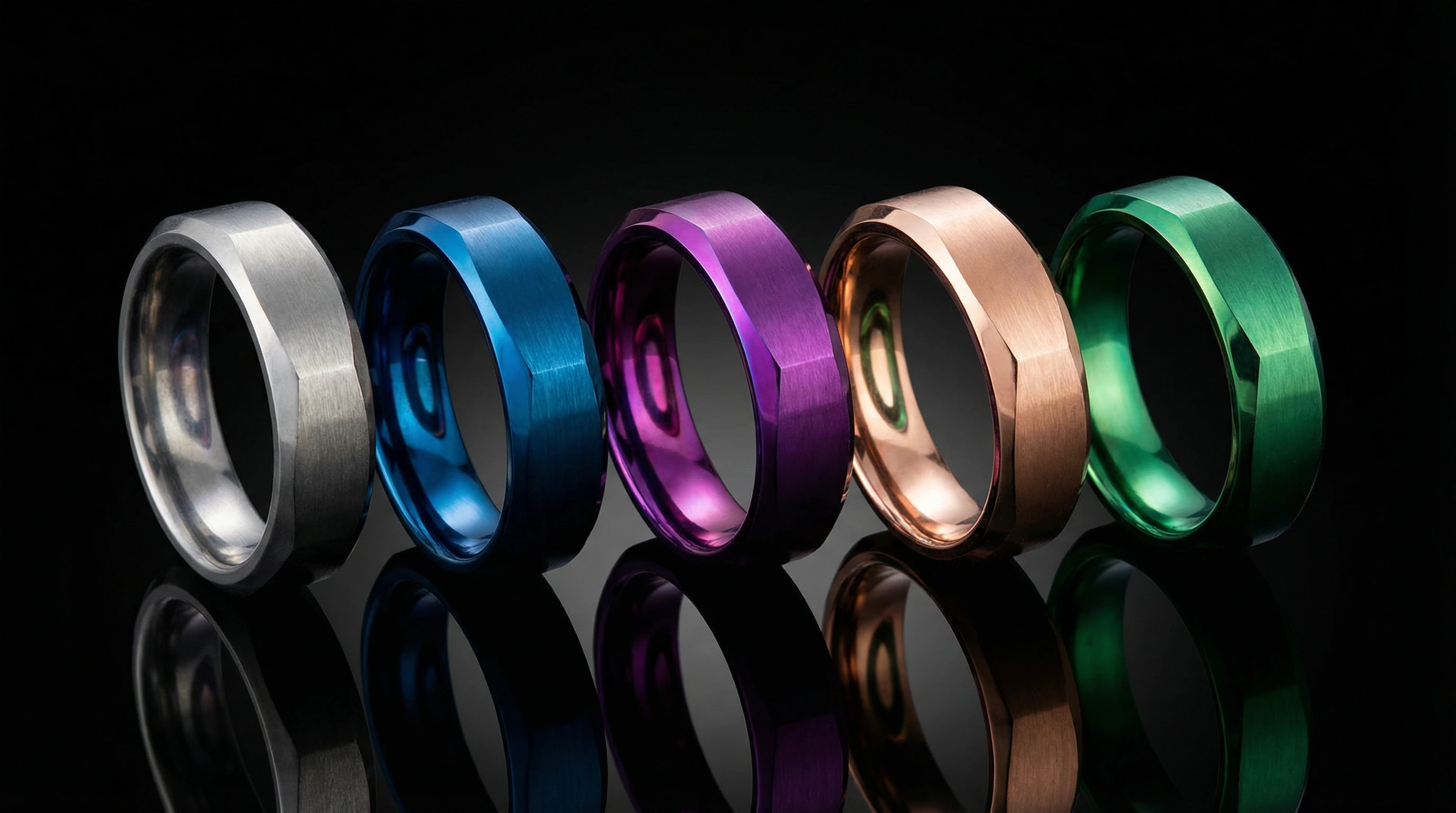 The Ultimate Guide to Titanium Jewelry: 8 Surprising Facts You Need to Know 4 Five titanium rings arranged in a row, each showcasing a different vibrant color achieved through the anodizing process, including blue, purple, rose gold, and green.