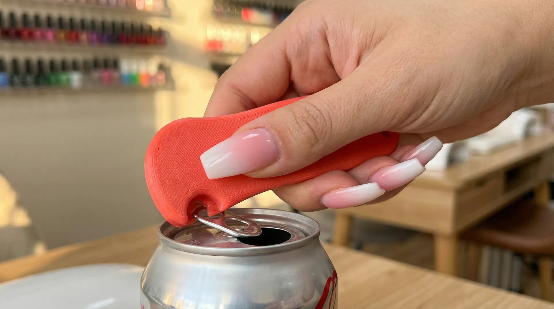 Nail salon client using can opener