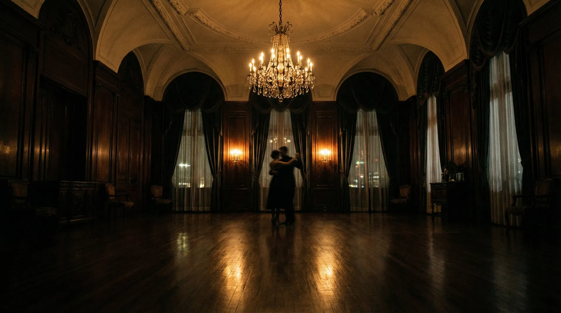 Grand ballroom with crystal chandelier and silhouetted dancers