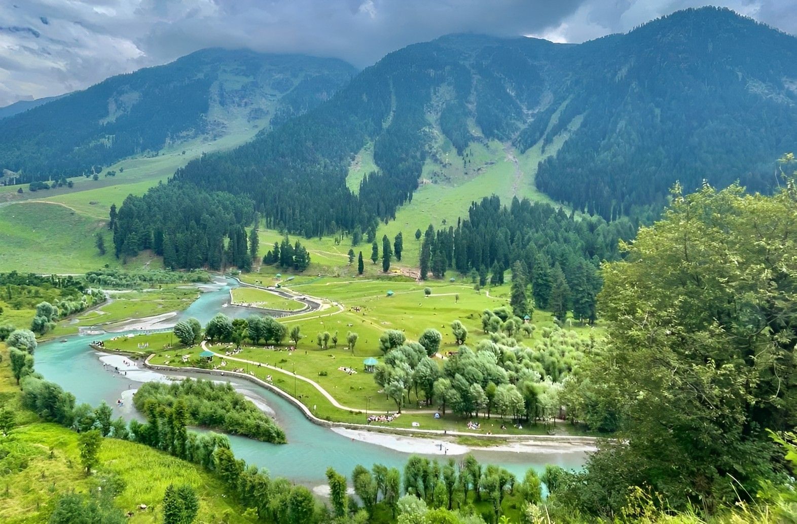 Pahalgam landscape with a river and mountains.