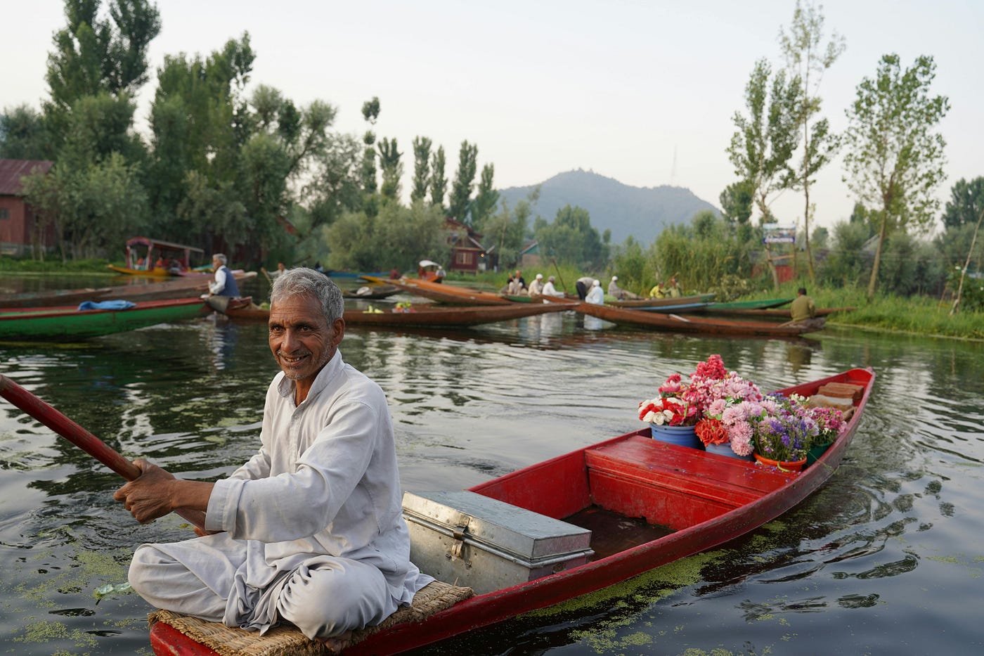 Local Kashmiri people engaged in traditional crafts and hospitality.