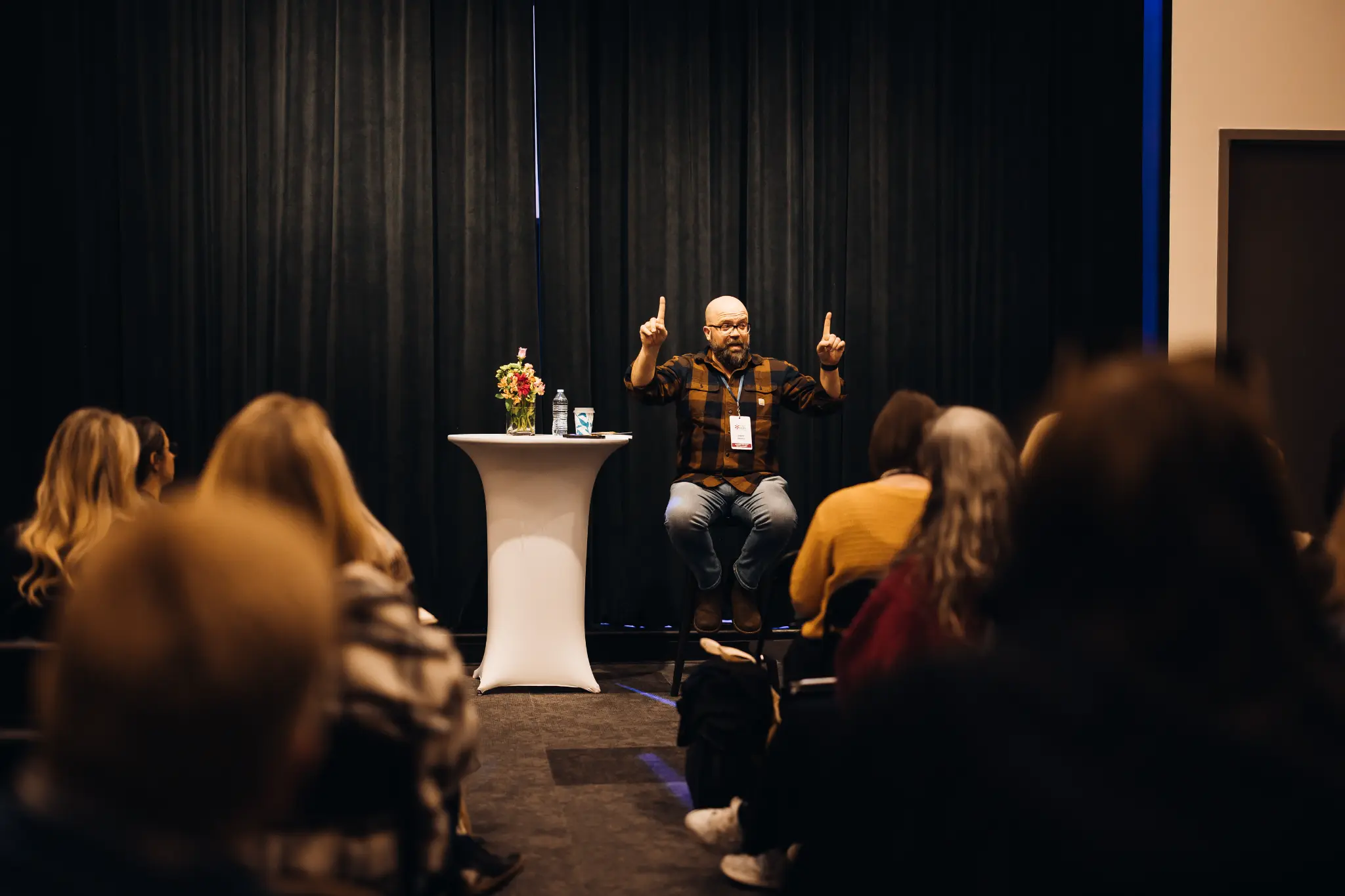 Adam Loomis speaking at an event 1