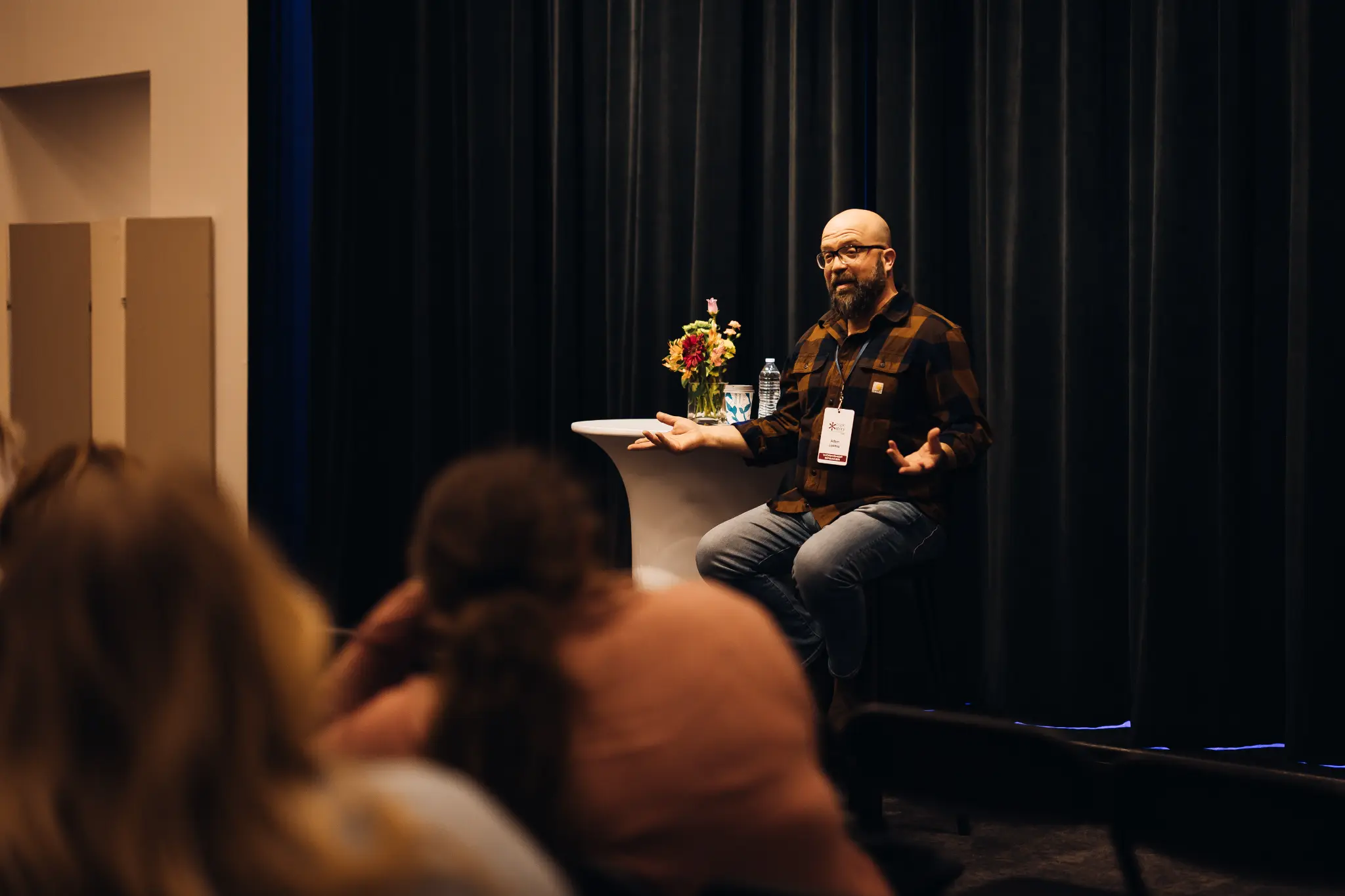 Adam Loomis speaking at an event 2