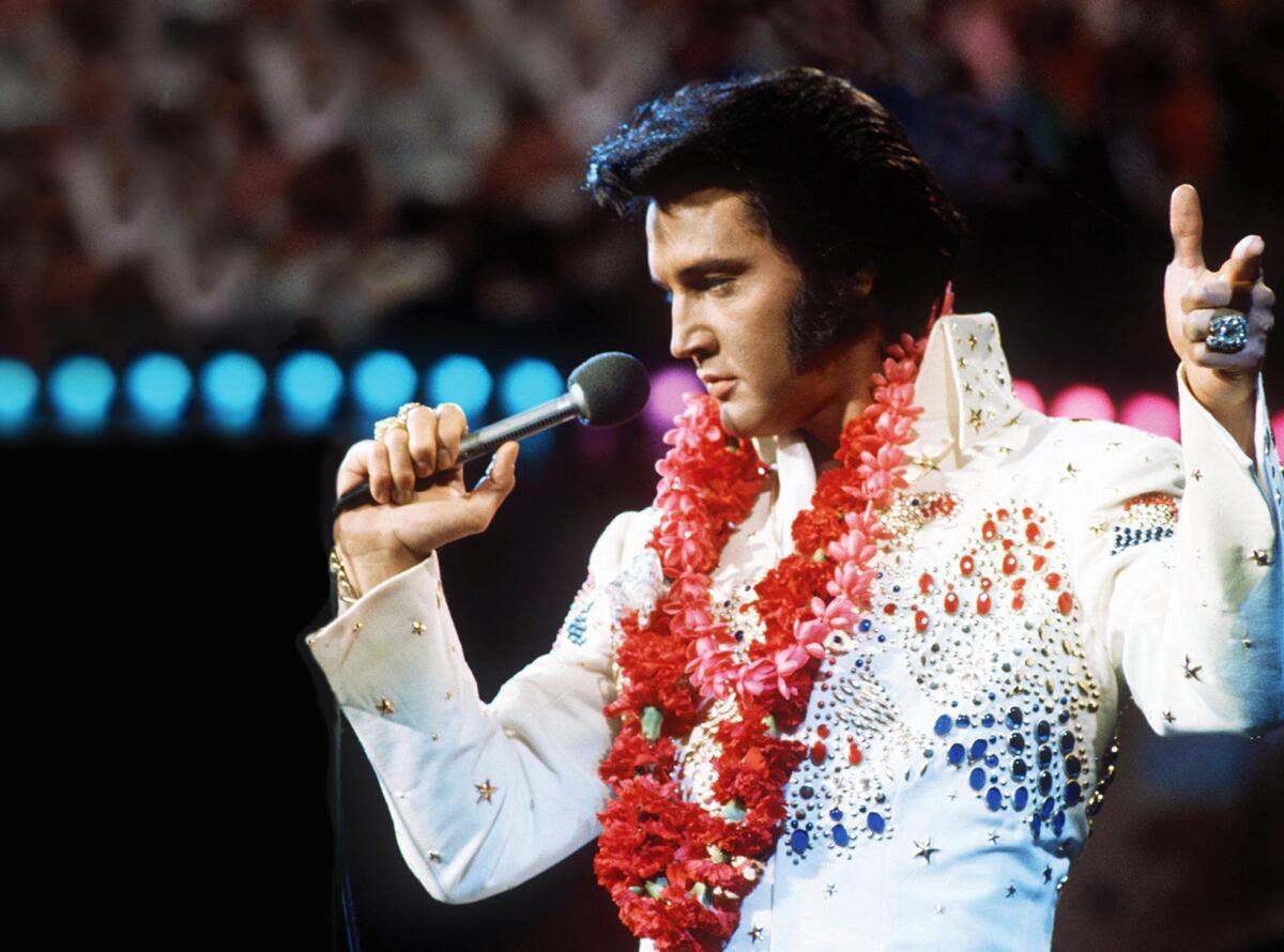 Elvis in the iconic white jumpsuit during the Aloha from Hawaii concert, 1973