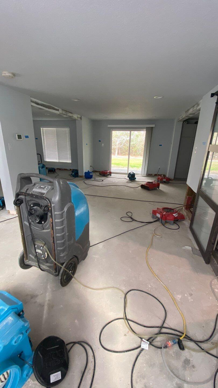 Water damage restoration — kitchen with drying equipment