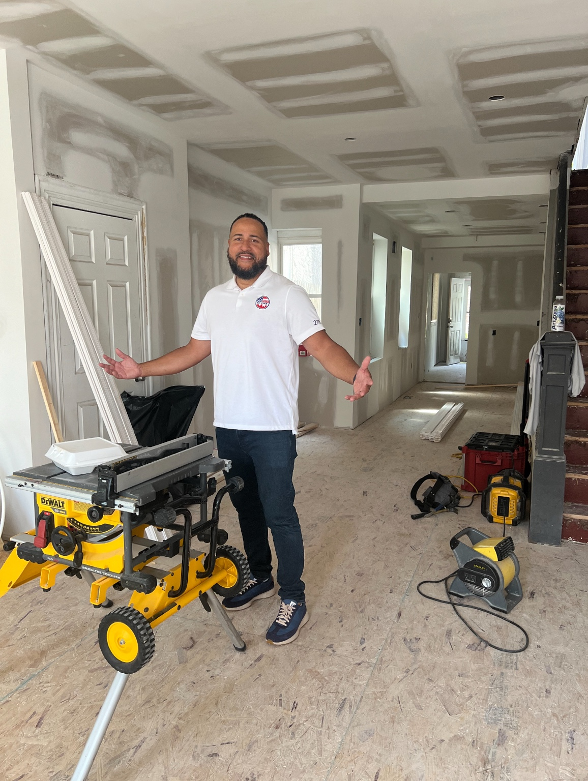Christopher Pitt, Founder of ReSkill To Own, standing inside an active construction renovation project
