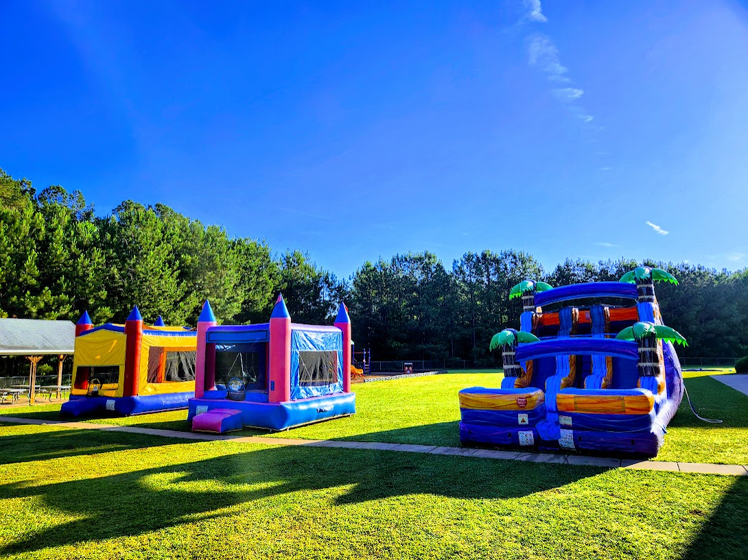 Water Park Setup — Community Festival, GA Wow Inflatables large inflatable water park rental with multiple slides at community festival in Middle Georgia