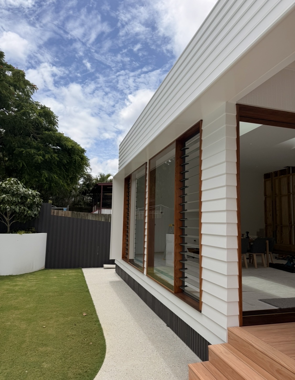 White Cladding With Timber Feature Windows