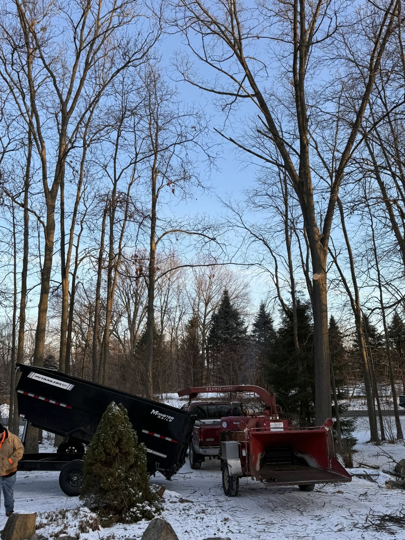 Crane truck and chipper set up for winter tree removal