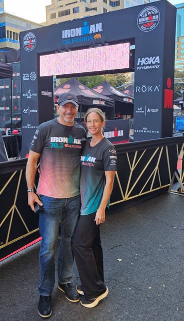 Michelle crossing the Ironman Texas finish line — bib #746