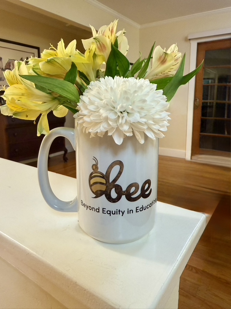 BEE journal notebook on a wooden shelf