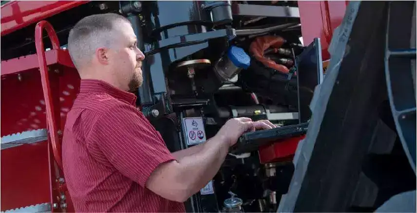 Afrimech service technician with CASE IH equipment