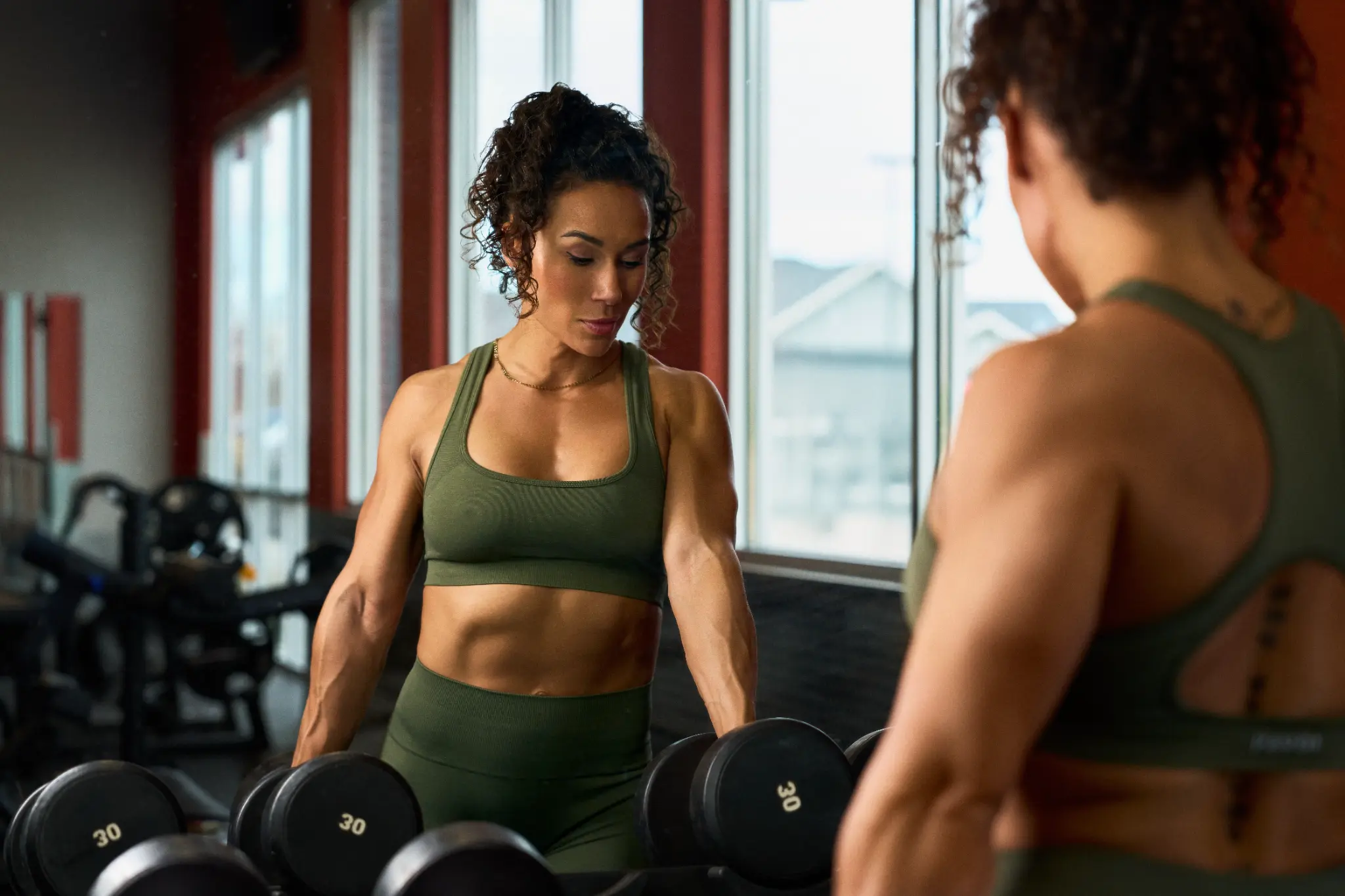 Ashley working out with dumbbells